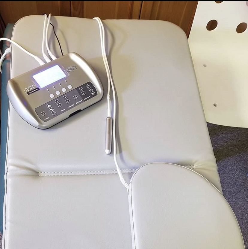PEMF therapy device resting on a padded treatment table in a clinic setting